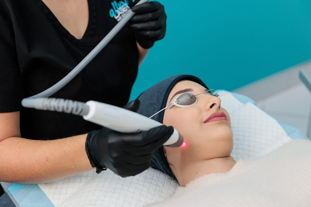 Woman undergoing laser genesis facial treatment