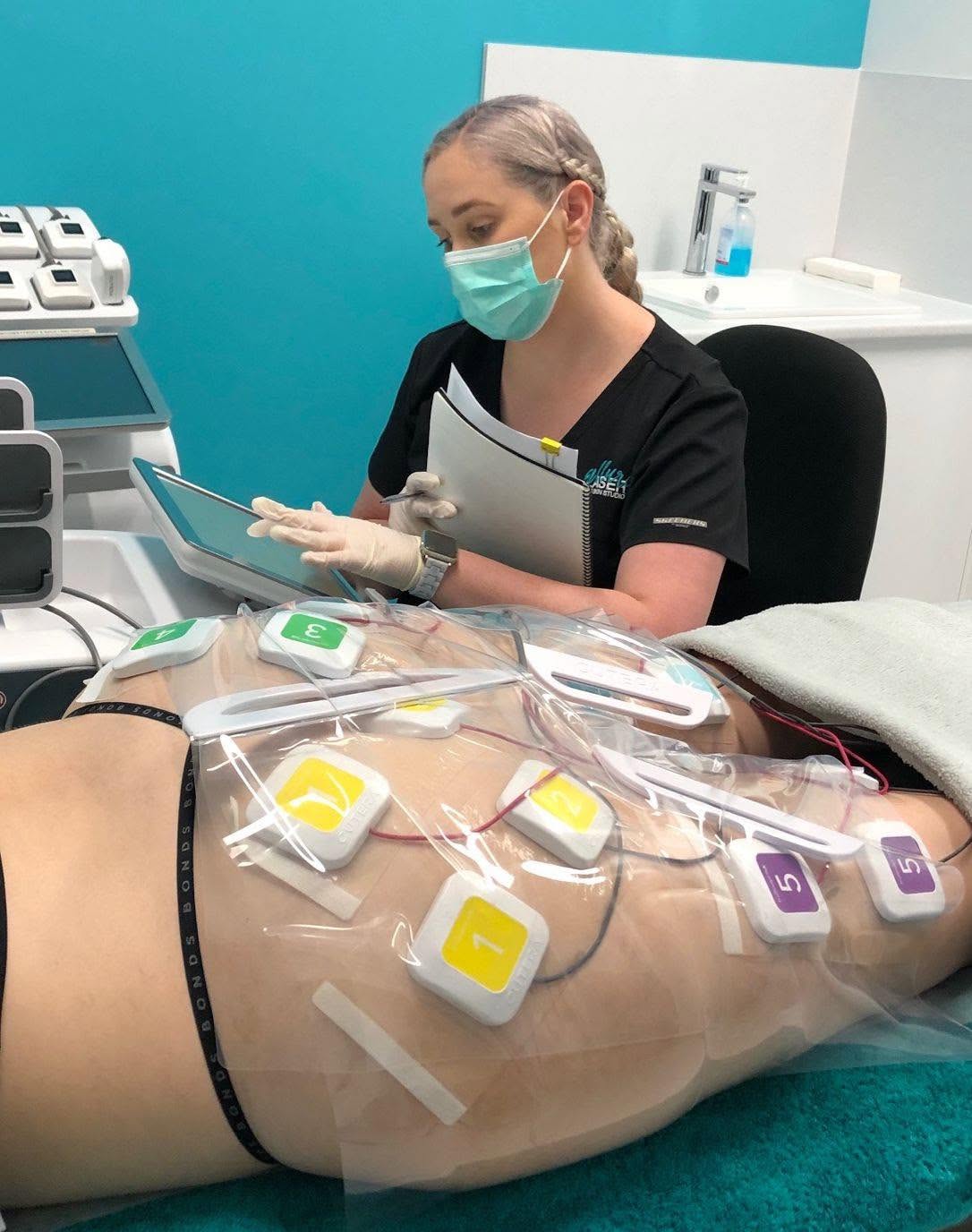 Woman undergoing truSculpt flex treatment