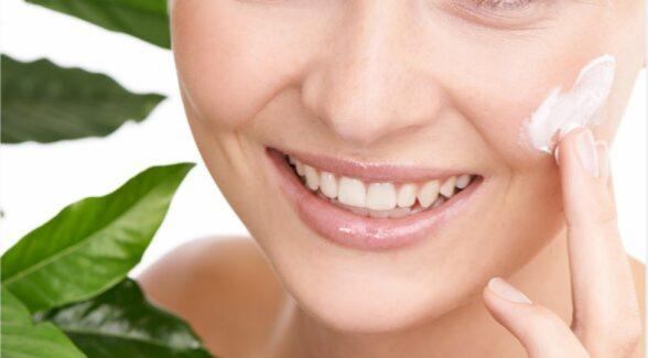 Woman applying skincare product to her face